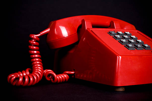 Vintage red telephone on black.
