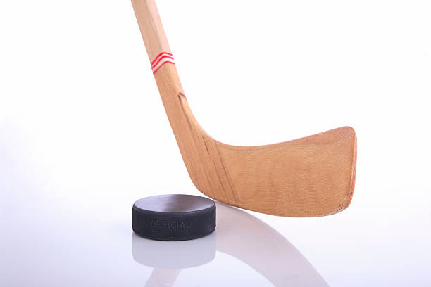 istock Wooden hockey stick & puck reflected on white background  179305824