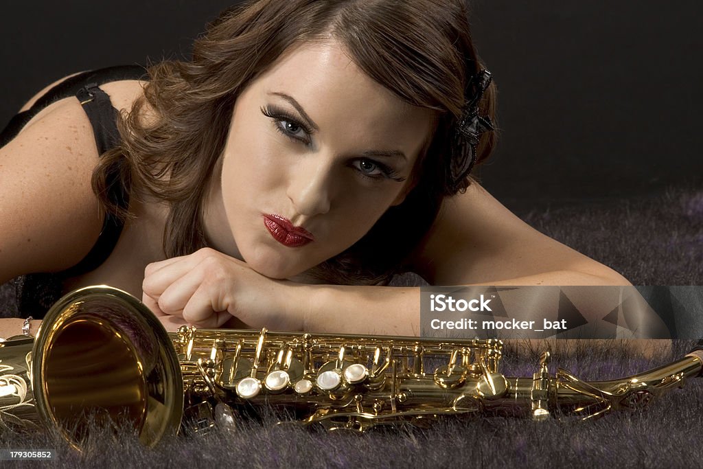 Woman portrait with saxophone in retro style Portrait of female with saxophone in retro lingerie 16-17 Years Stock Photo