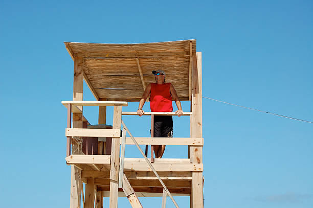 Man in lifeguard tower stock photo