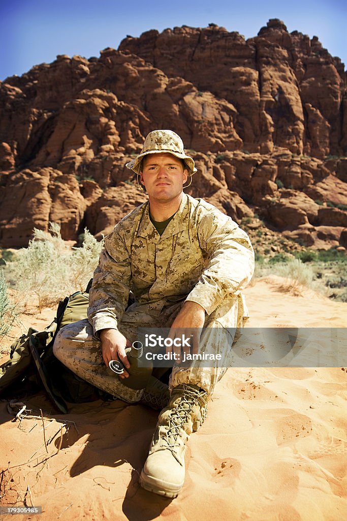 Soldier A US Marine sitting in the desert sand taking a break.Utah RedRockalypse Armed Forces Stock Photo