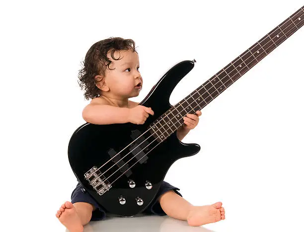 Portrait of the little  guitarist on a white background.
