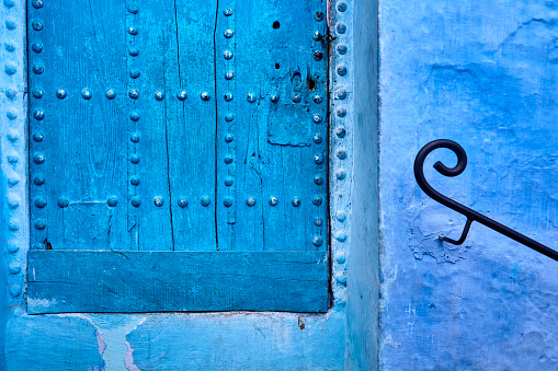 Blue door with decorative door nails in Chefchaouen, Morocco, Africa.