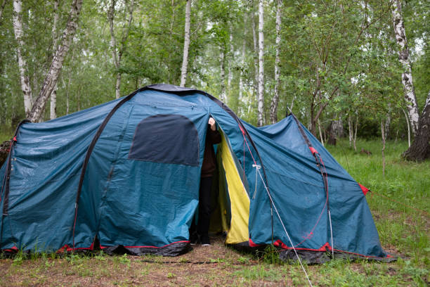 istock A woman sets up a tent in the forest 1793085435