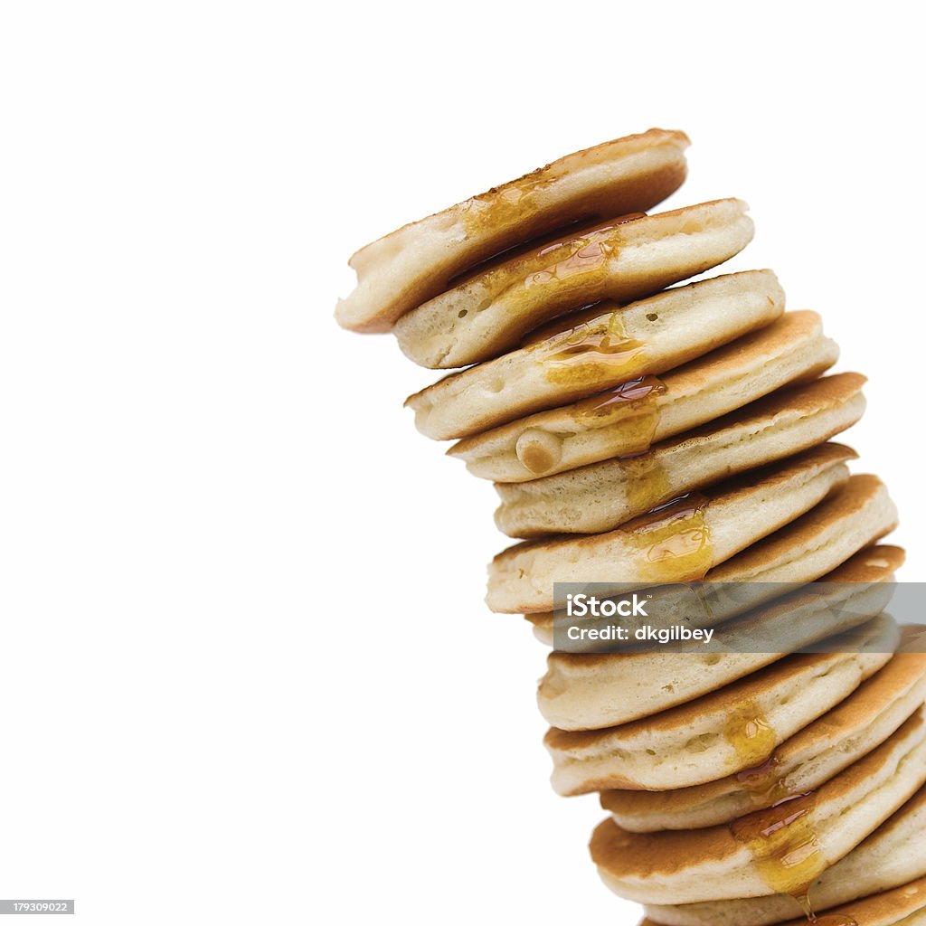 Leaning tower of pancakes Really tall stack of panckes with maple syrup dripping down the side - no calories to be seen! Pancake Stock Photo