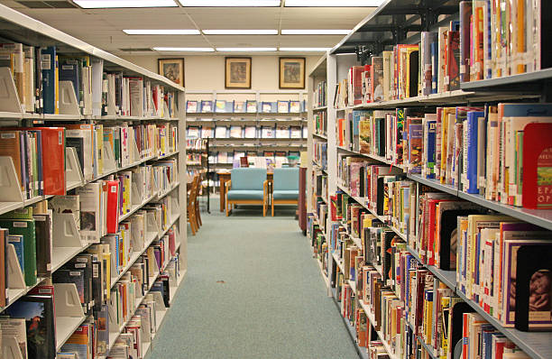 istock A library aisle of book shelves 179310124