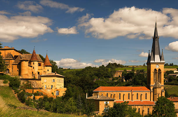 Beaujolais scenery "Image shows an old chateau and a church in a village in the famous wine making region of Beaujolais, France" beaujolais region stock pictures, royalty-free photos & images