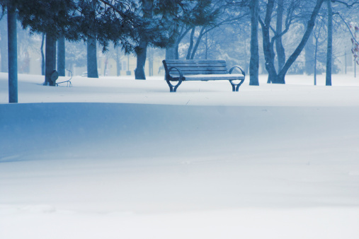 Lonely park bench on a snowy day