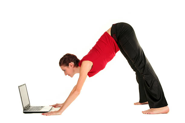 istock Woman doing yoga with laptop 179311627