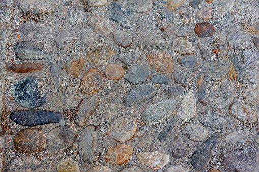 Aosta, Italy - August 5, 2023: Cobblestones with rusted nail in the old town.