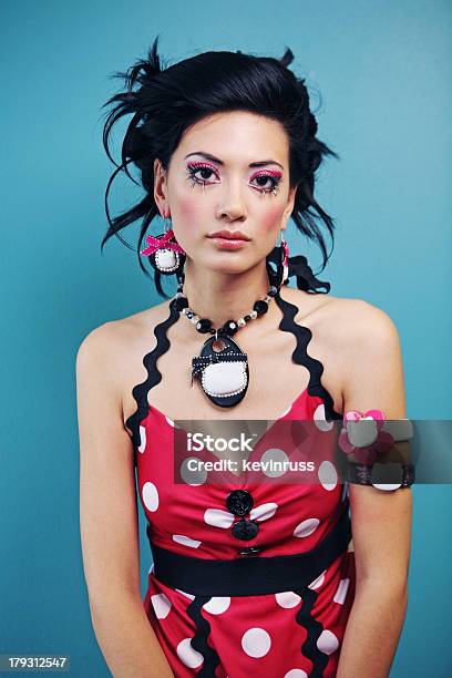 Woman In Polka Dot Dress On Blue Wall Stock Photo - Download Image Now - Adult, Adults Only, Asian and Indian Ethnicities