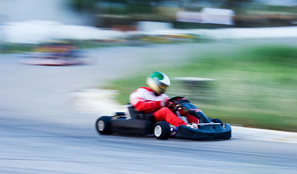 istock Man in red racing a go kart on a track 179312652