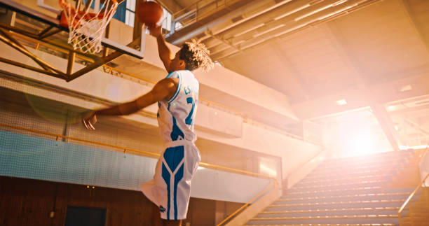 istock Man throwing basketball towards basket 1793136478