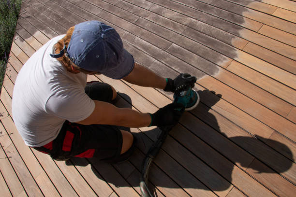 istock Man sanding and cleaning wooden deck with the power sander 1793141880