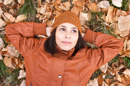 Portrait of young woman lying down on the ground.