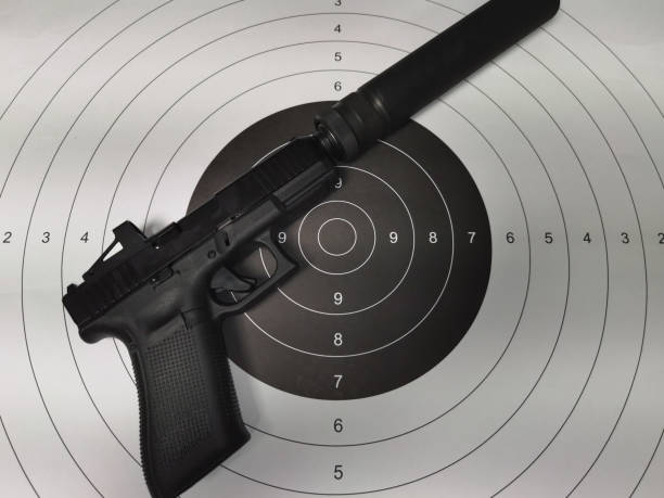 istock Paper target for shooting and pistol with silencer and red dot. 1793157333