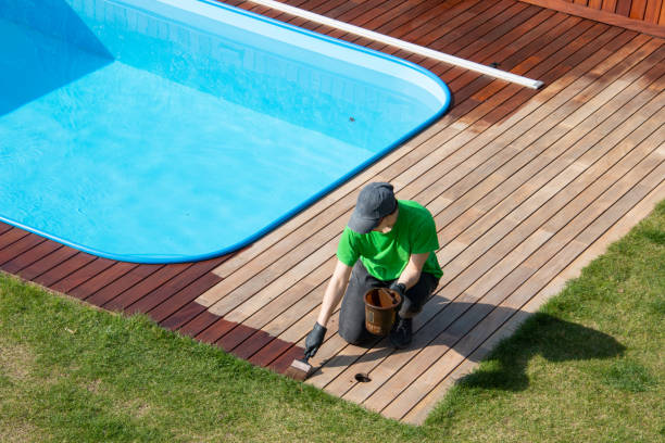 istock A worker painting exterior wooden pool deck with decking oil 1793159420