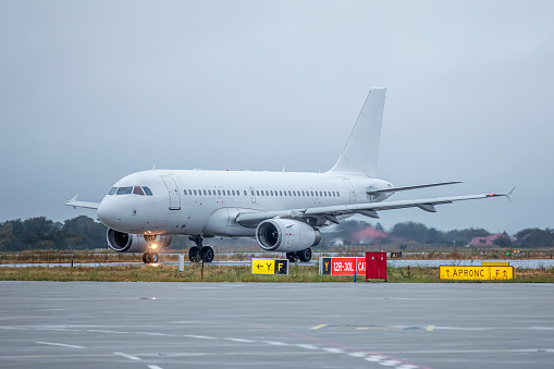 White commercial aircraft without markings and registration at the airport on the gate preparing for departure. Aircraft without markings ideal for mockup.