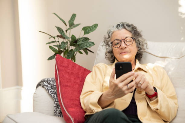 istock Woman sitting on a sofa and using a smart phone 1793160598