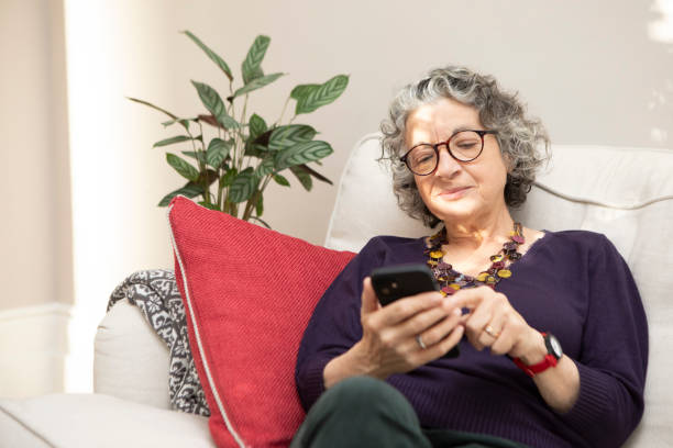 istock Woman sitting on a sofa and using a smart phone 1793160622