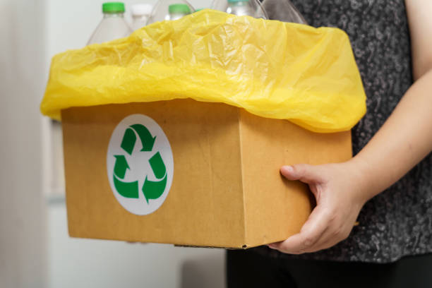 istock Home recycle eco green zero concept Woman throwing empty plastic bottle in recycling bin with yellow garbage bags at home. 1793161161