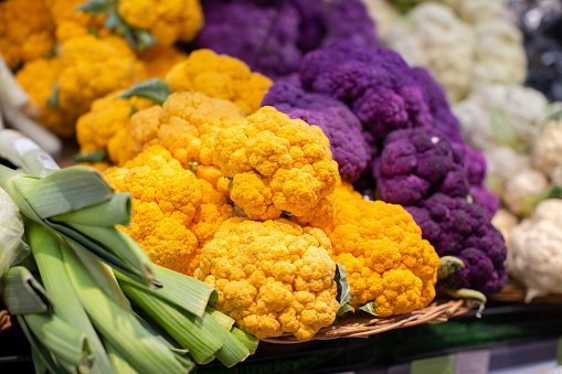 Multi-colored cauliflower on a supermarket shelf.