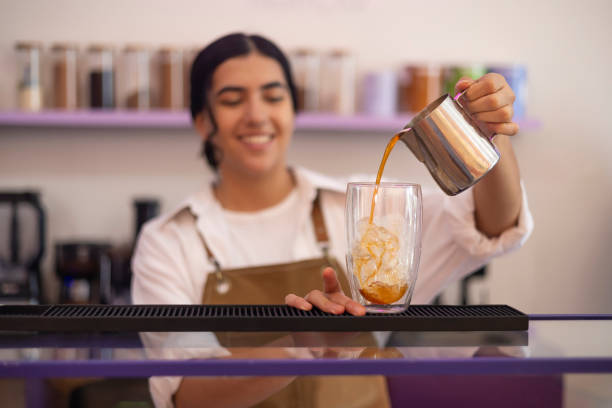 Portrait of a young woman pouring a cold brew