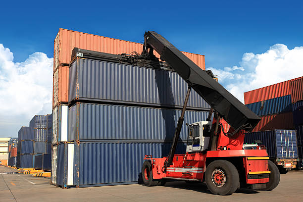 istock Crane lifting up container in railroad yard 179318131