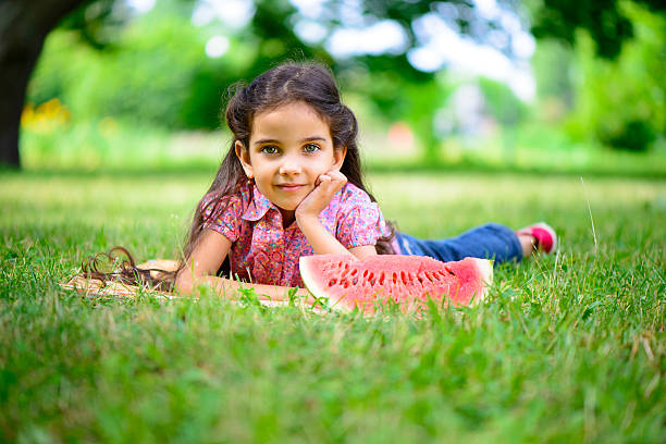 istock Cute hispanic girl eating watermelon 179318196