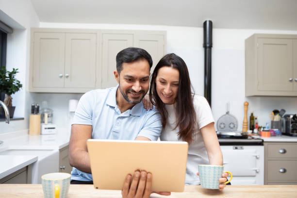 istock Man and woman using a digital tablet in a kitchen 1793187656