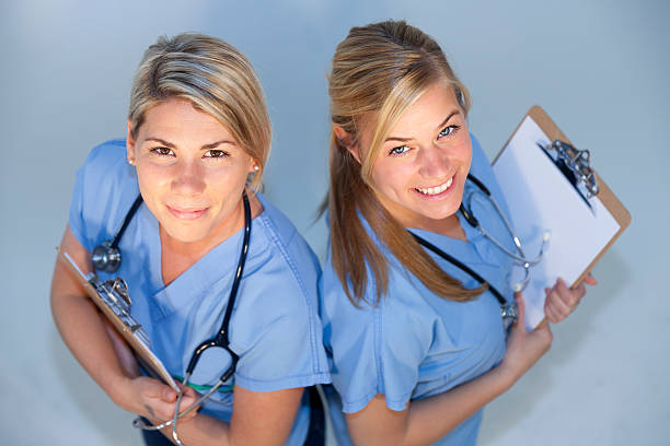 Overview of two happy health care professionals smiling stock photo