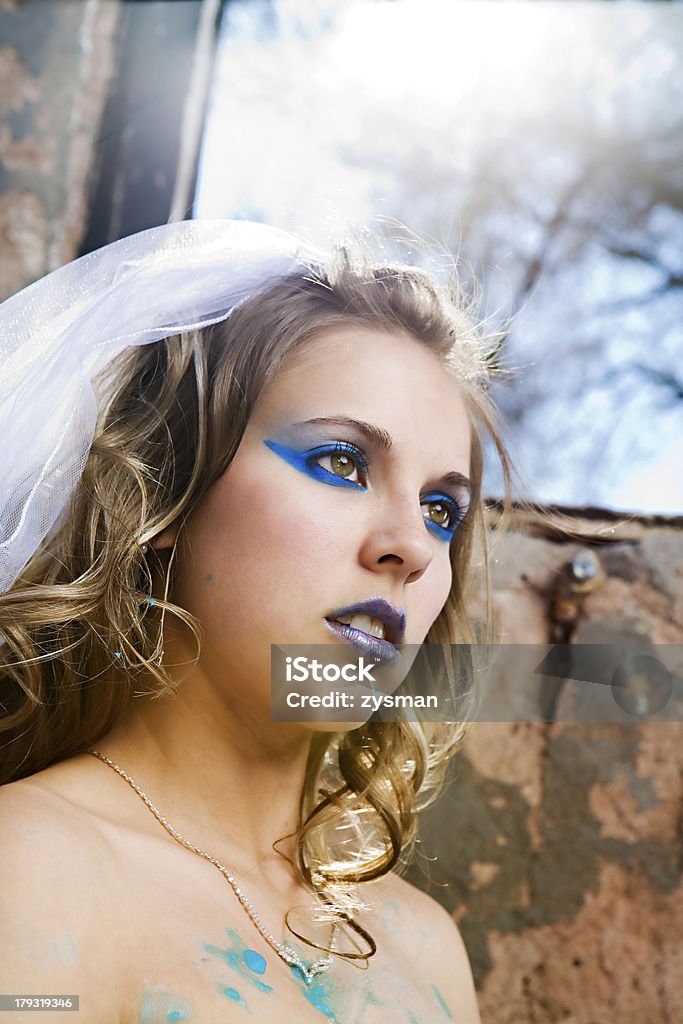 Blue Paint Bride A bride with heavy makeup trashes her wedding gown using blue paint Adult Stock Photo