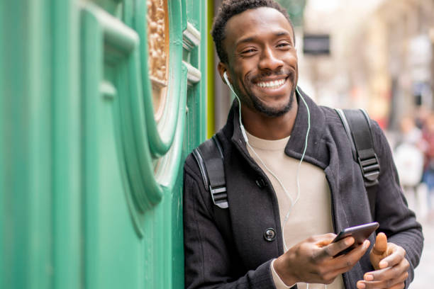 istock Black-skinned man using mobile phone in the city 1793206043