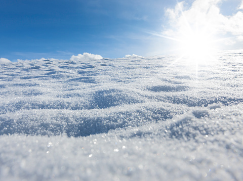 Sunbeams over a snowfield close-up