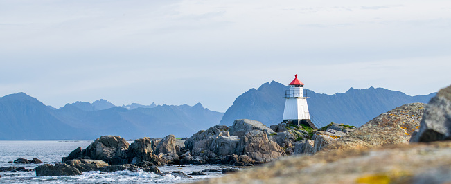 norwegian see with small islands and a picturesque lighthouse.