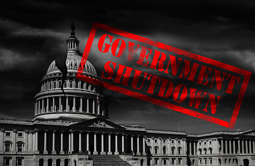 The United States capitol building with a crack and red Government Shutdown stamp
