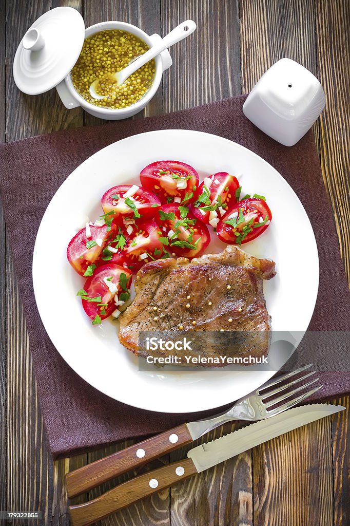 Freshly cooked steak with tomato salad and mustard Steak Appetizer Stock Photo