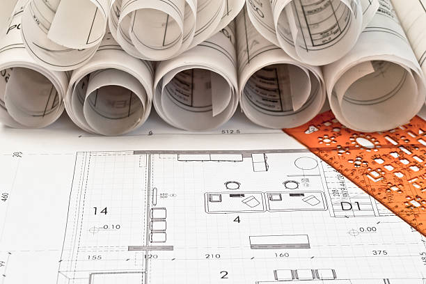 Rolls of architectural designs and blue prints stock photo
