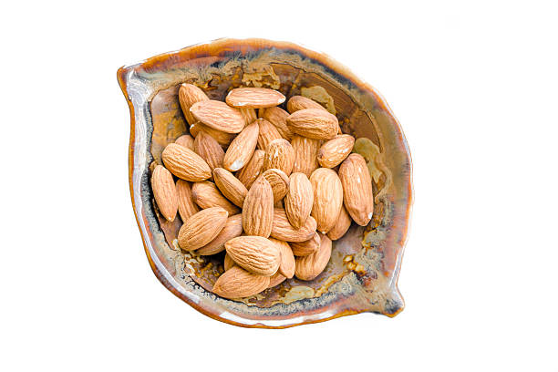 istock Bowl full of almonds on white with shadow 179323184