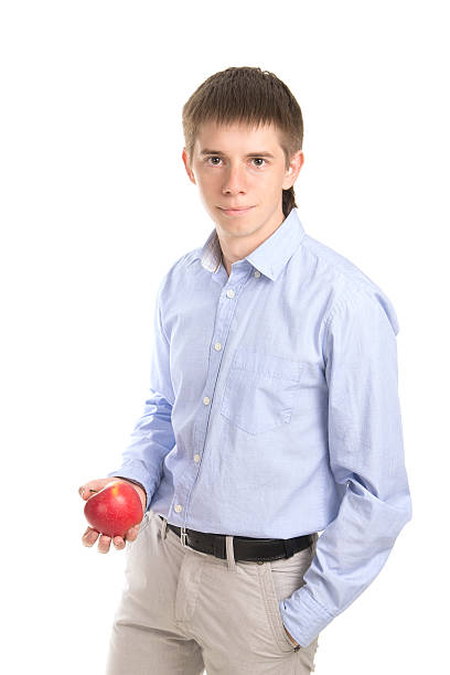 istock manl holding a yellow apple 179323365