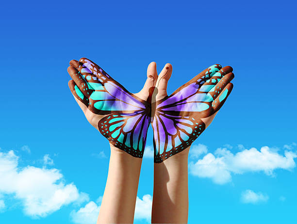 Hand and butterfly Hand and butterfly hand painting, tattoo, over a blue sky, concept for spiritual symbol of soul body paint stock pictures, royalty-free photos & images