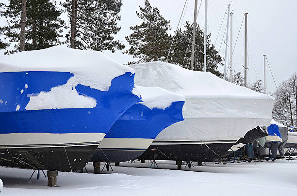 covered boats in winter stock photo