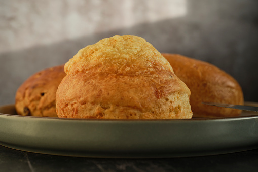 Close up of a plate of scones, front scone is a Cheese scone.