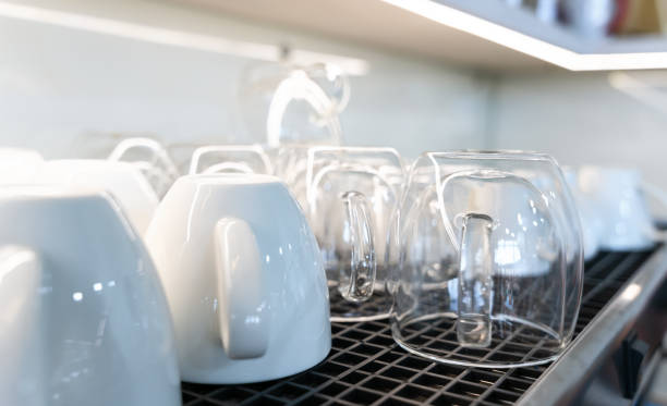 istock Clean glass and ceramic coffee cups lie upside down on a coffee machine in a cafe. Close-up. Selective focus. 1793239595
