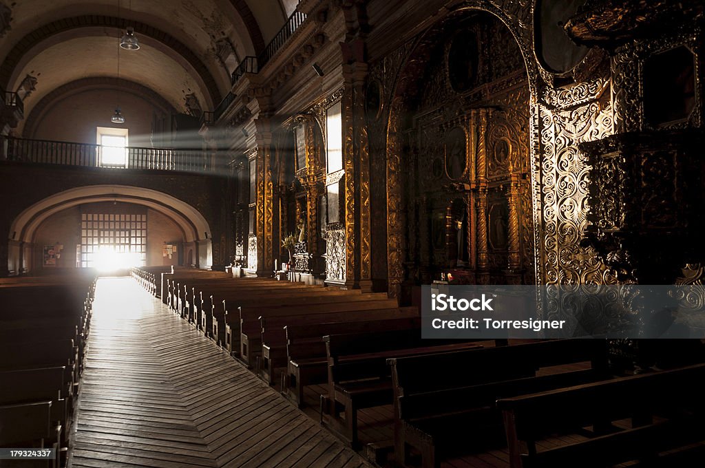 Church Interior Inside a church looking along the corridor down a misterious lights effect. Santo Domingo Church, San Cristobal de las Casas, Chiapas, Mexico. Ancient Stock Photo