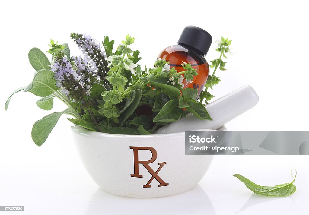 Porcelain mortar with rx symbol and fresh herbs Botany Stock Photo