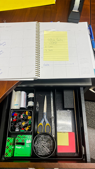 An office organizer is used to make for an organized desk with all the necessary office supplies.