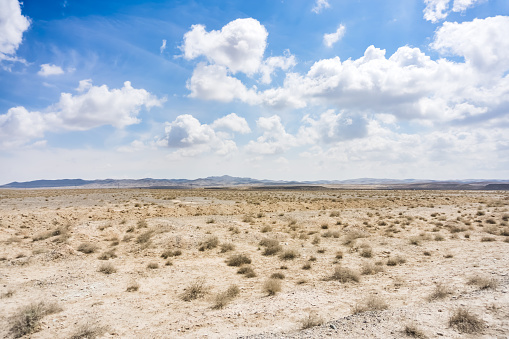 Panoramic view of a mountain range in the desert in cloudy summer weather
