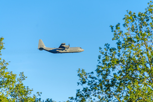 OLDENZAAL, NETHERLANDS - SEPTEMBER 6, 2023: \nLow flying C-130H lockheed Martin Hercules of the Dutch Royal Airforce. It is a four-engine turboprop military transport aircraft.