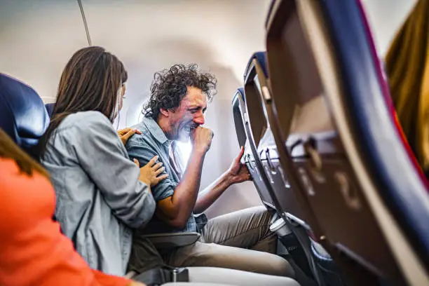 Photo of Male passenger having a panic attack on airplane flight